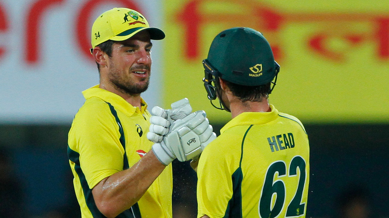 Moises Henriques celebrates with Travis Head after Australia beat India by 8 wickets.
