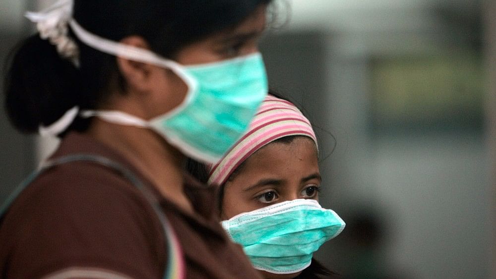 A woman and a child wear masks against air pollution in Delhi.