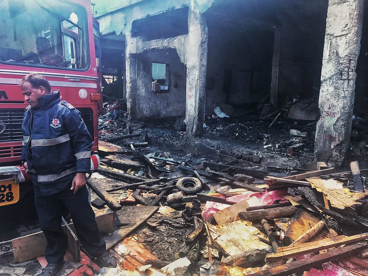 A fire-fighter stands at the spot where the fire started. 