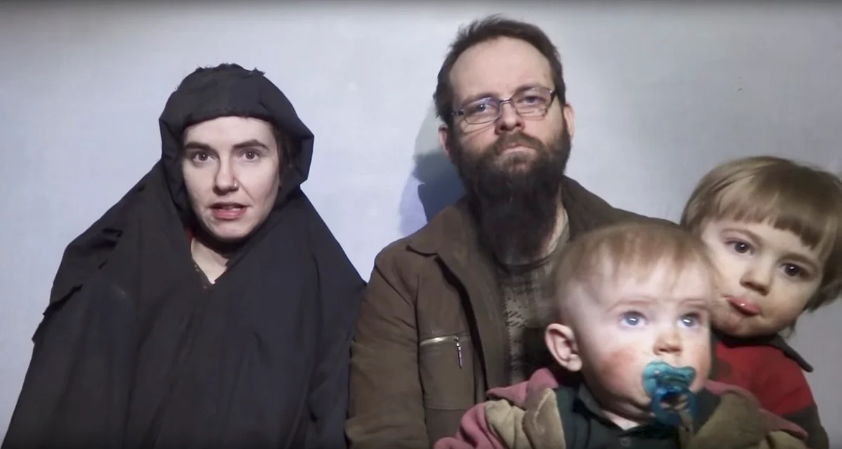 In this file image from video released by Taliban Media in December 2016, Caitlan Coleman talks in the video while her Canadian husband Joshua Boyle holds their two children.
