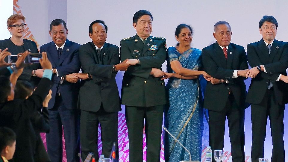 From left, Australian Defense Minister Marise Payne, Brunei Darussalam Defense Minister Mohammad Yasmin bin Haji Umar, Cambodian Defense Minister Samdech Pichey Sena Tea Banh, Chinese Defense Minister Gen. Chang Wanquan, Indian Defense Minister Nirmala Sitharaman, Indonesian Defense Minister Ryamizard Ryacudu, and Japanese Defense Minister Itsunori Onodera, link arms for a photo session at the two-day ASEAN Defense Ministers’ Meeting and its Dialogue Partners 