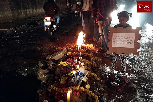 Residents perform last rites of a pothole