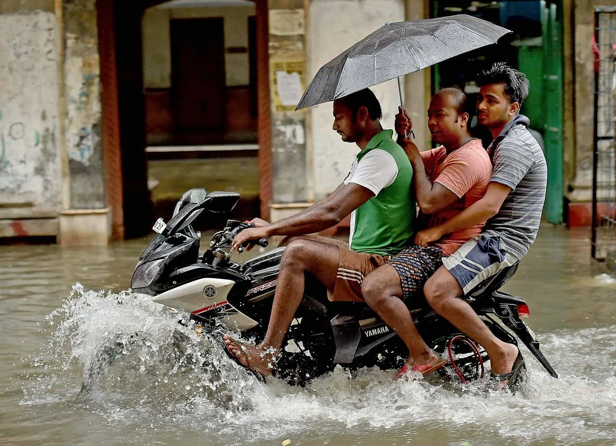 People on a motorcycle wade through a flooded street in Kolkata on Monday.
(Photo: PTI)