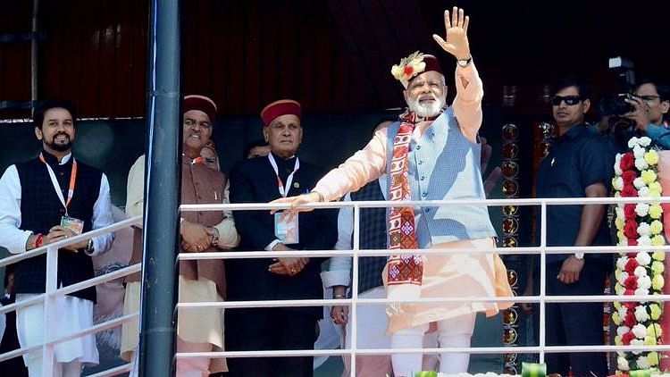 Prime Minister Narendra Modi waves at BJP supporters during the ‘Parivartan rally’ in Shimla.