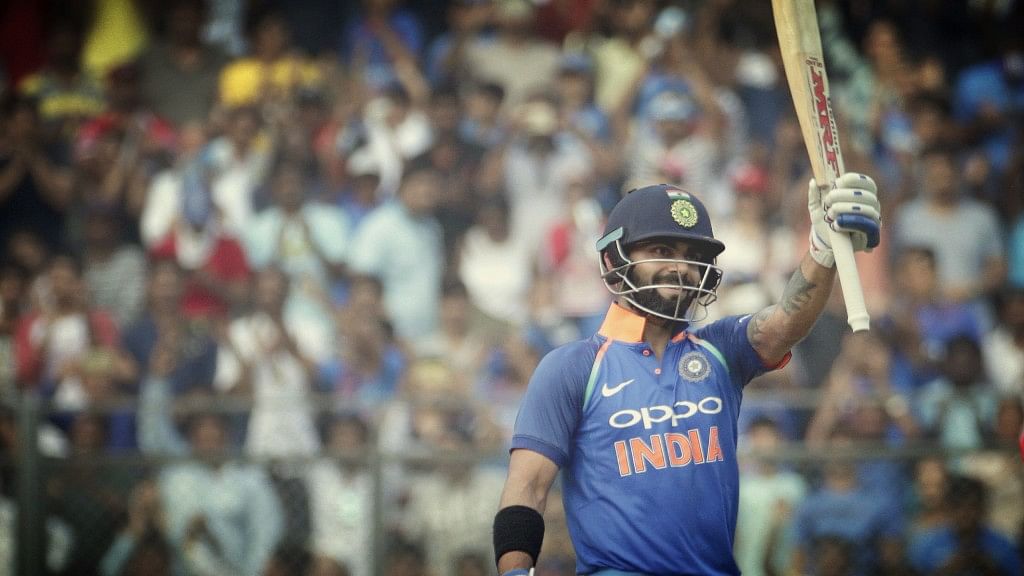 Virat Kohli celebrates scoring a century in his 200th ODI.