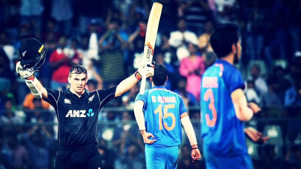 New Zealand’s Tom Latham raises his bat after scoring hundred runs during their first one-day international cricket match against India in Mumbai