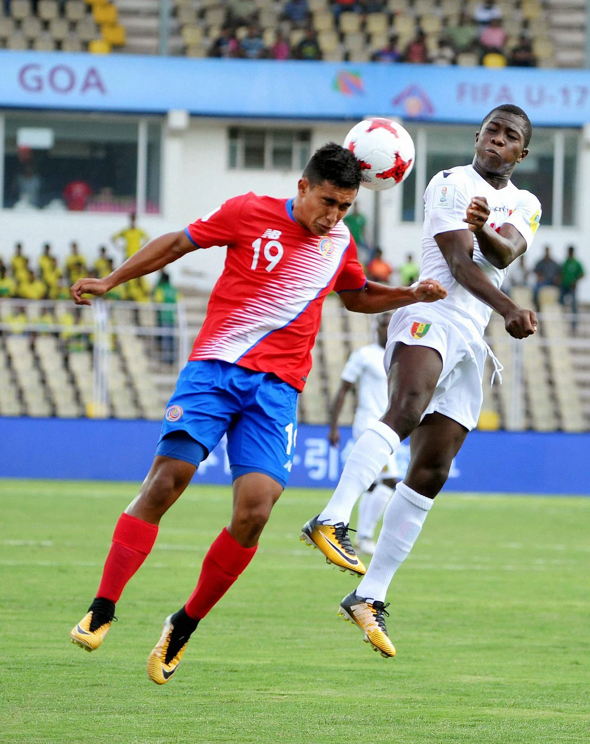 Players of Costa Rica and Guinea vie for the ball during their U-17 FIFA World Cup football match at Pandit Jawaharlal Nehru Stadium, Goa.