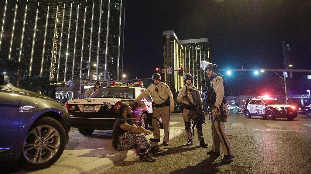 Police officers stand at the scene of a shooting near the Mandalay Bay resort and casino on the Las Vegas Strip.