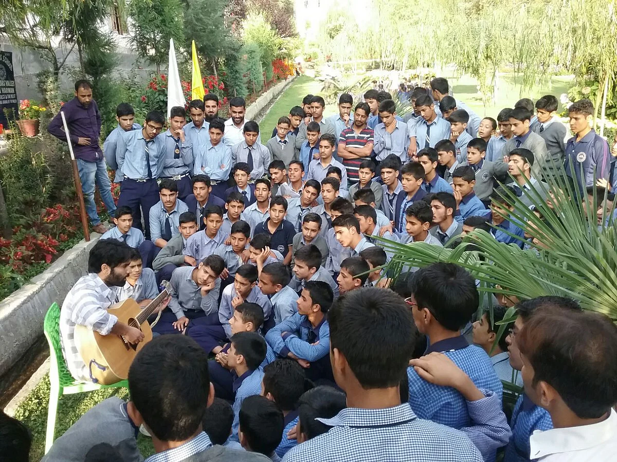 Musician Ovais Ahmad performs at Scholars Boarding School, Harwan, on the International Day of Peace.