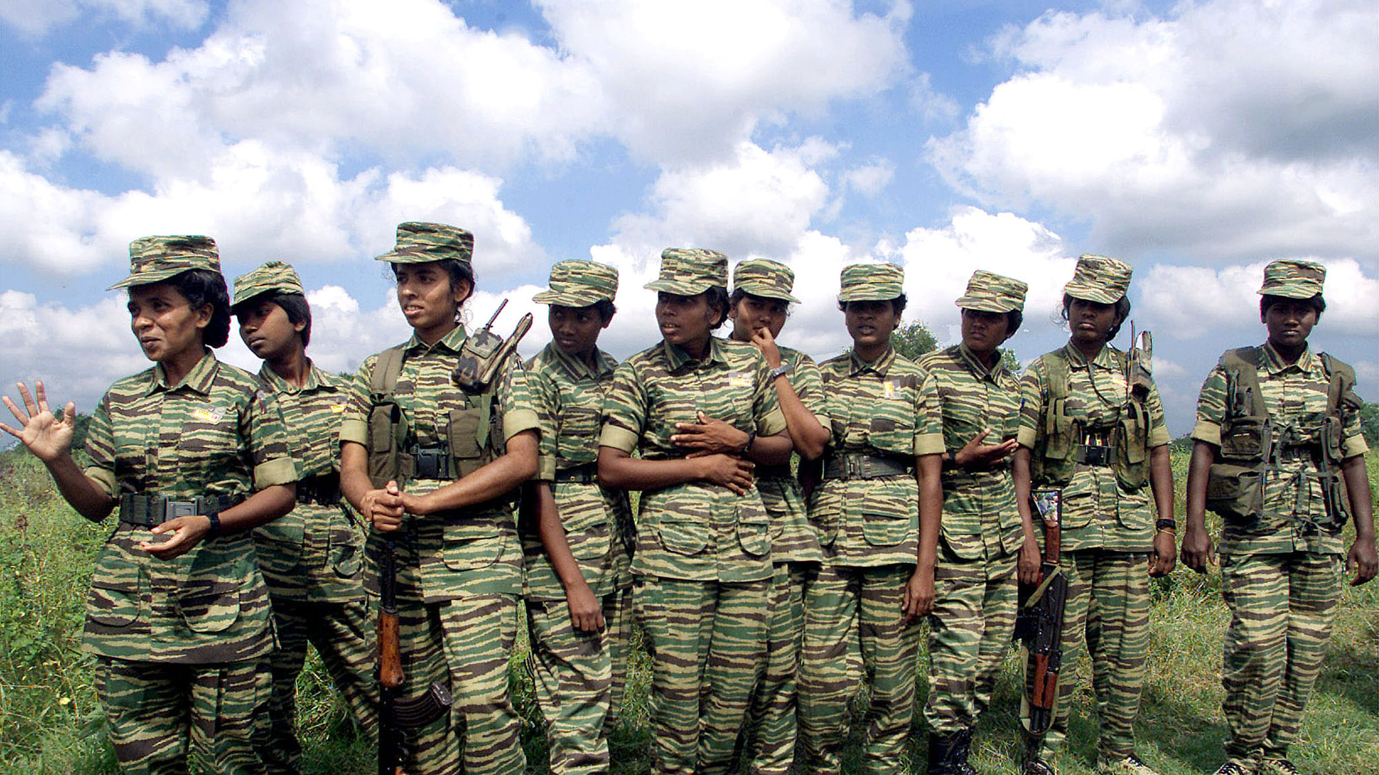 Women fighters of the Liberation Tigers of Tamil Eelam (LTTE) stand on the rebel side of a border crossing in Omanthai in north-central Sri Lanka on 15 February 2002.&nbsp;