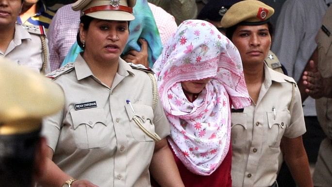 Honeypreet Insan, head covered with scarf, leaves after being produced in court in Panchkula.