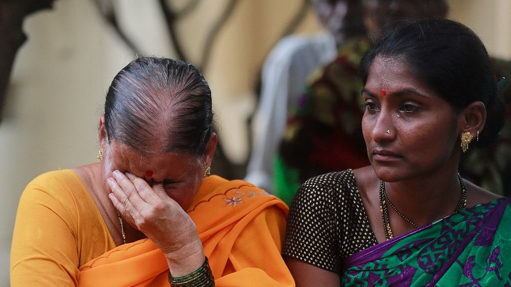 Women mourn outside a morgue for relatives killed in the stampede at Mumbai’s Elphinstone Road station.