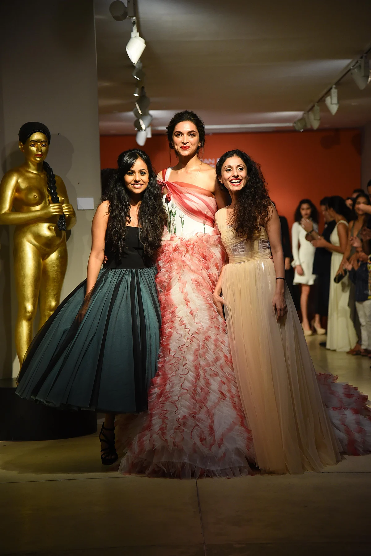 Deepika flashes a smile with her delighted designers.