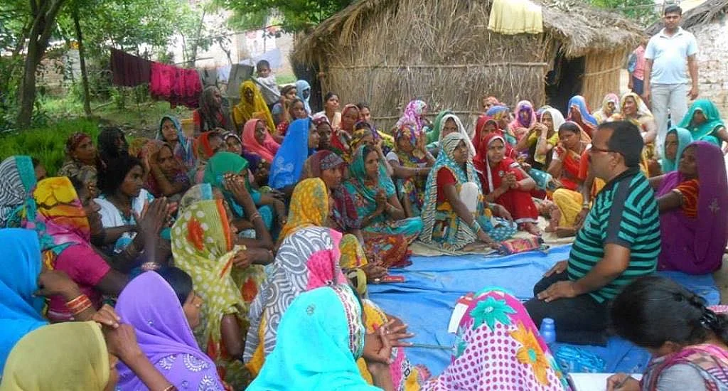 Women of Nari Sangh, the collective, hold discussions with representatives of a community-based organization about the village clinic. 