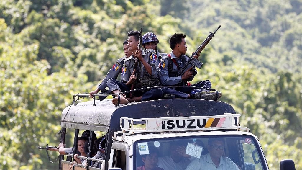Police guard  UN convoy which carries INGO and UN staff, as they flee from Maungdaw after the Arakan Rohingya Salvation Army (ARSA) attack, in Buthidaung, Myanmar.