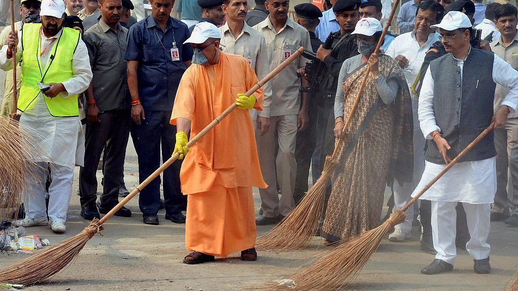 Chief Minister Yogi Adityanath wields a broom as he takes part in a cleanliness drive at the western gate of the Taj Mahal in Agra.