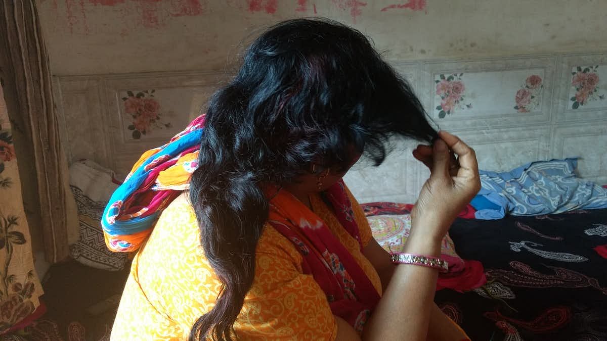 A Delhi resident shows where her hair was chopped off when the choti cutting scare took the capital by storm. Image used for representation.