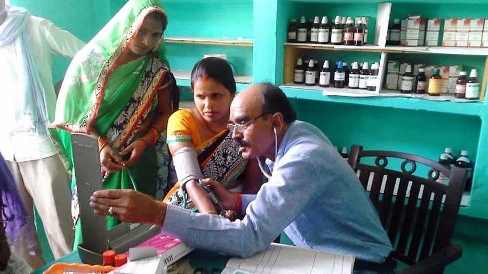 A doctor attends to patients at Gaon Dawakhana, the community-owned village clinic that runs on family subscriptions.&nbsp;