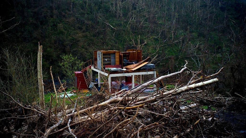 In this file photo, the foundation of a heavily damaged house stands in the mountains after the passing of Hurricane Maria in the San Lorenzo neighborhood of Morovis, Puerto Rico.