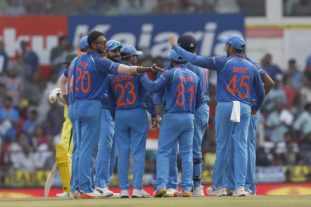 The Indian team celebrate a wicket.