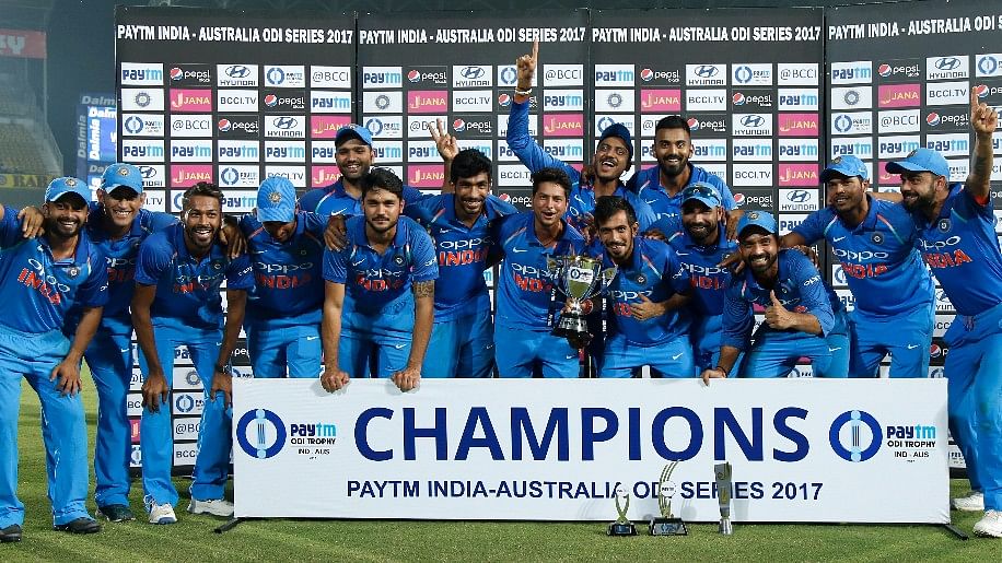 The Indian team pose with the ODI series trophy.