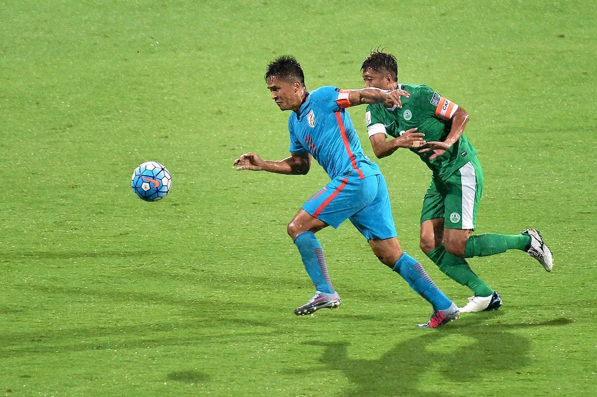 India’s Sunil Chettri and Macau footballer Cheang Cheng vie for the ball during the AFC Asian Cup qualifier match at Kanteerava Stadium in Bengaluru on Wednesday.