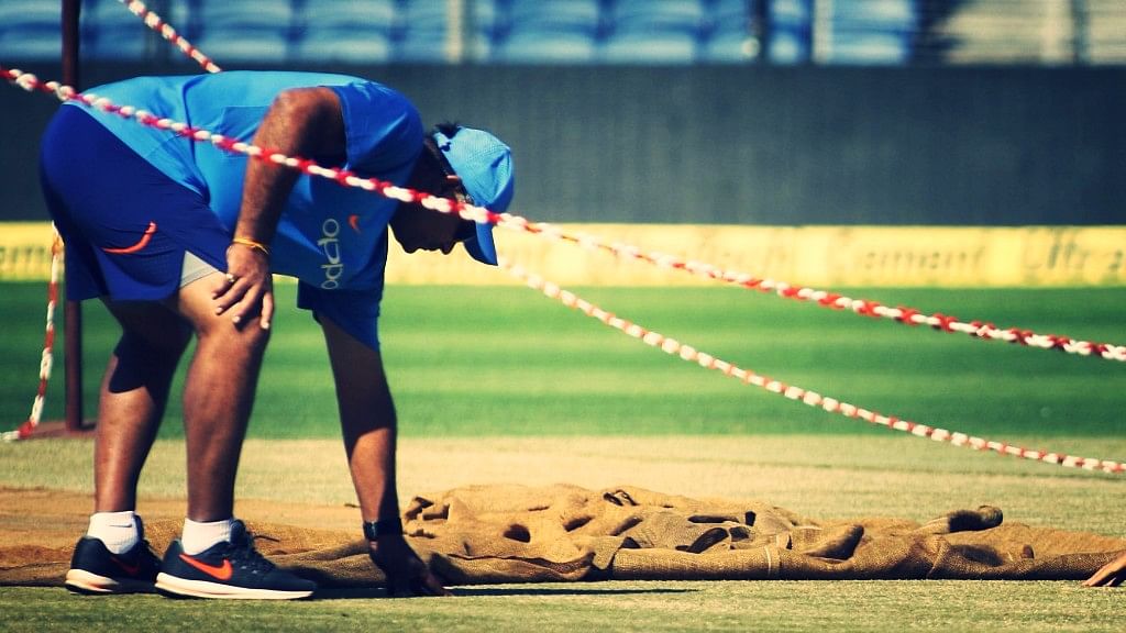 Pune: Indian bowling coach Bharat Arun inspects the pitch during a practice session in Pune on Oct 24, 2017.&nbsp;