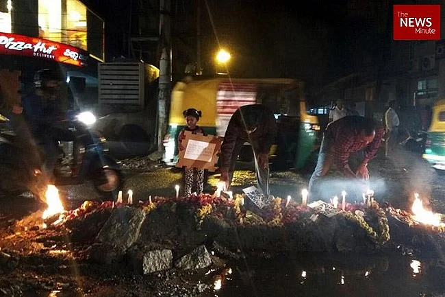 Residents performing last rites of a pothole
