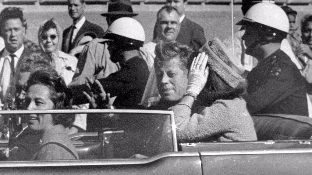In this 22 November 1963 file photo, President John F Kennedy waves from his car in a motorcade in Dallas, right before his assassination.&nbsp;