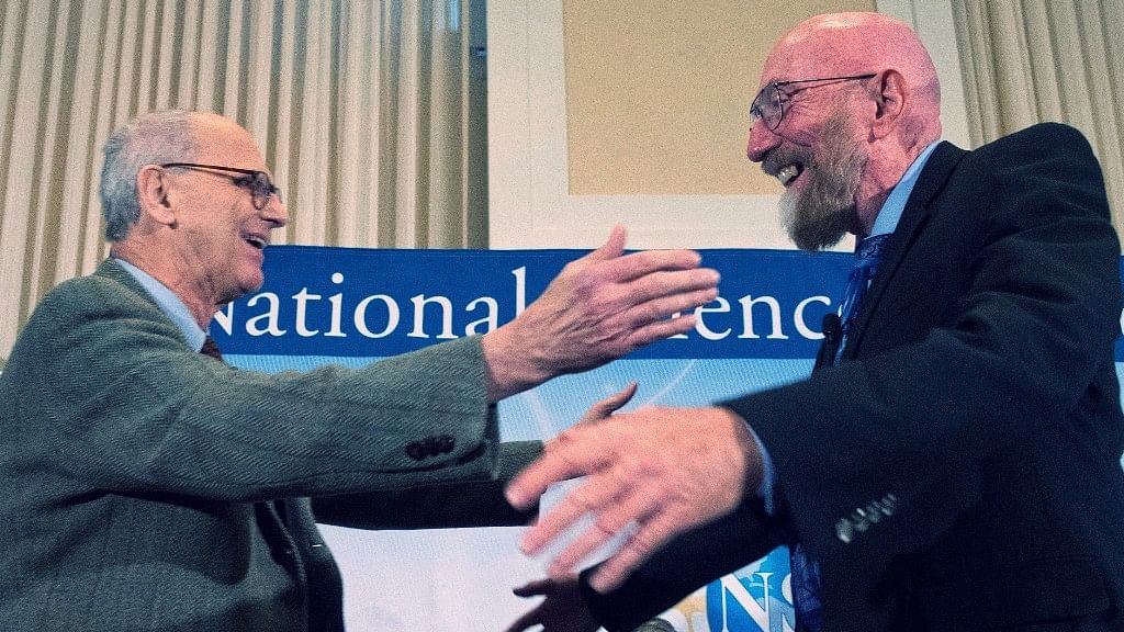In this 11 February 2016 file photo, Laser Interferometer Gravitational-Wave Observatory (LIGO) Co-Founder Rainer Weiss, left, and Kip Thorne, right, hug on stage during a news conference at the National Press Club in Washington, USA.&nbsp;