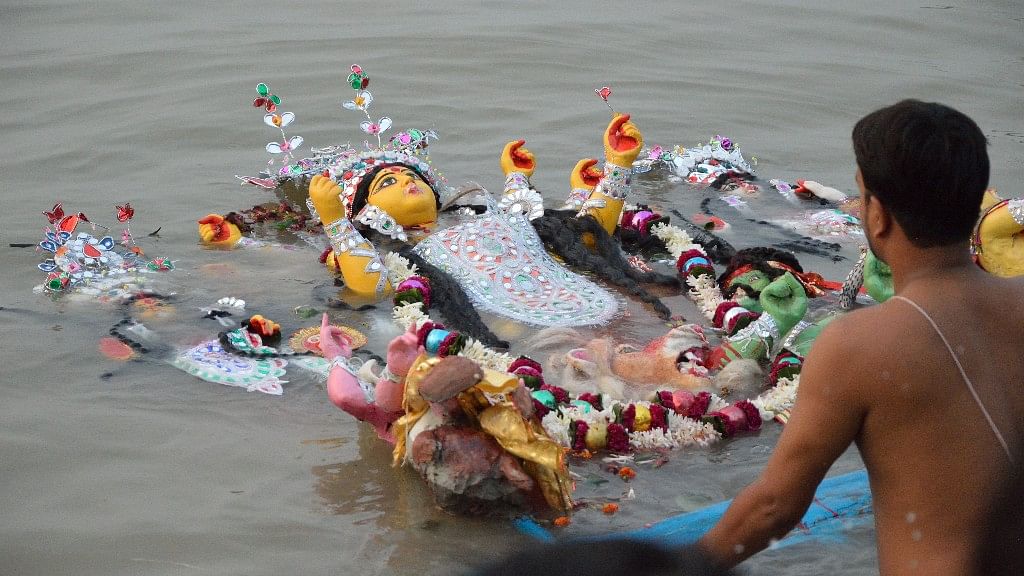 A Durga idol being immersed in the Hooghly river in Kolkata’s Baghbazar Ghat.