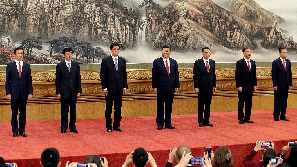 China’s  Politburo Standing Committee members (L-R) Han Zheng, Wang Huning, Li Zhanshu, Xi Jinping, Li Keqiang, Wang Yang and Zhao Leji, line up as they meet with the press at the Great Hall of the People in Beijing. File Photo.