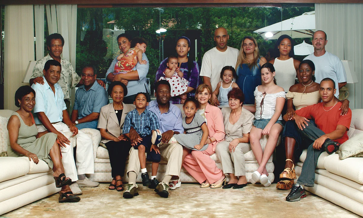 Brazilian football legend Pele sits for a portrait with his extended family, in his summer home in the Atlantic coastal city of Guaruja, in Sao Paulo state, 14 February 2003.