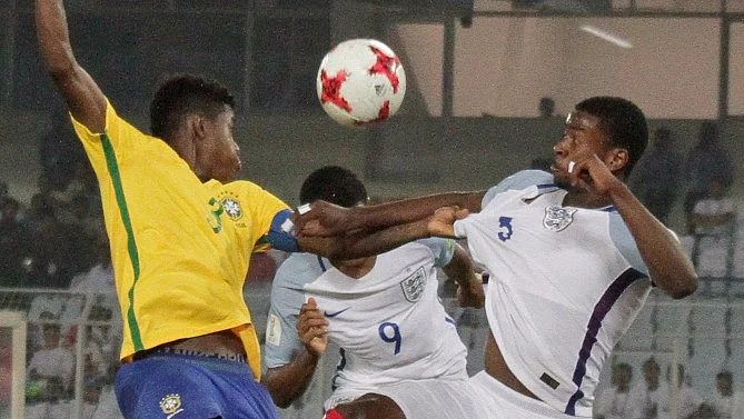 Brazil’s Vitao duels for the ball against England’s Rhian Brewster.