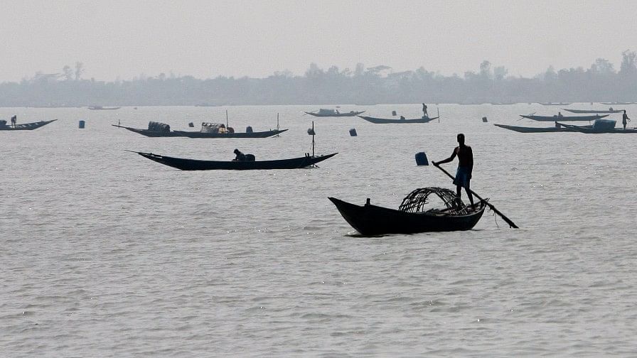 Fishermen row their boats in the Sunderbans. Image used for representation.