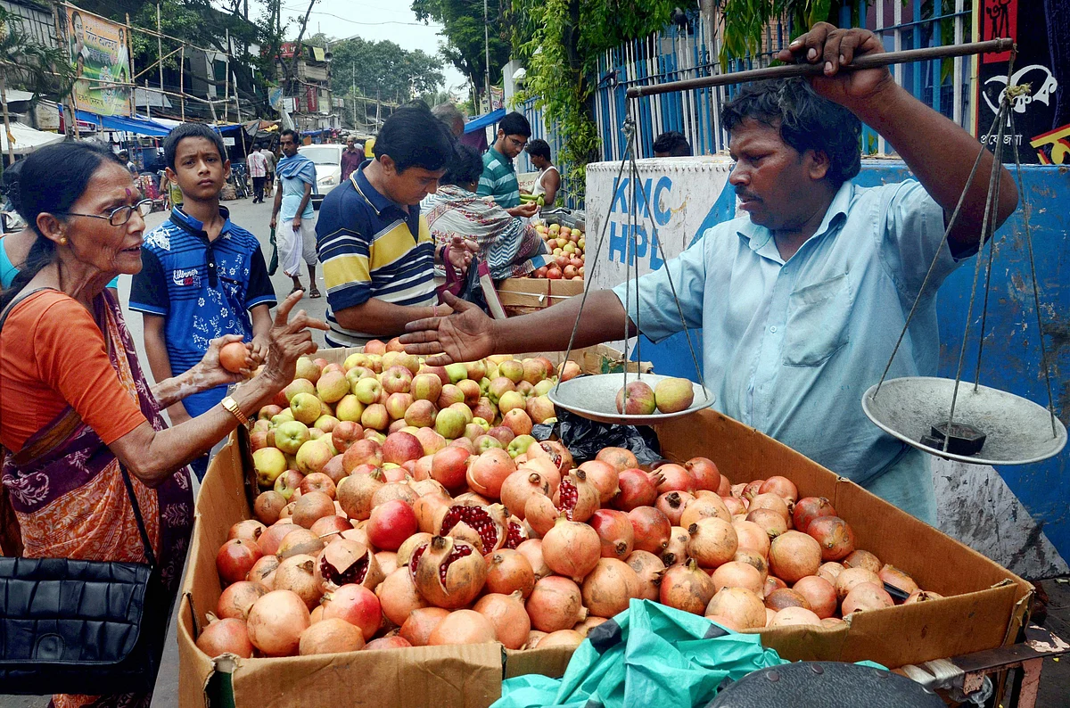 Customers queue up to buy fruits on the occasion of Lakshmi puja festival at a market in Kolkata on Thursday