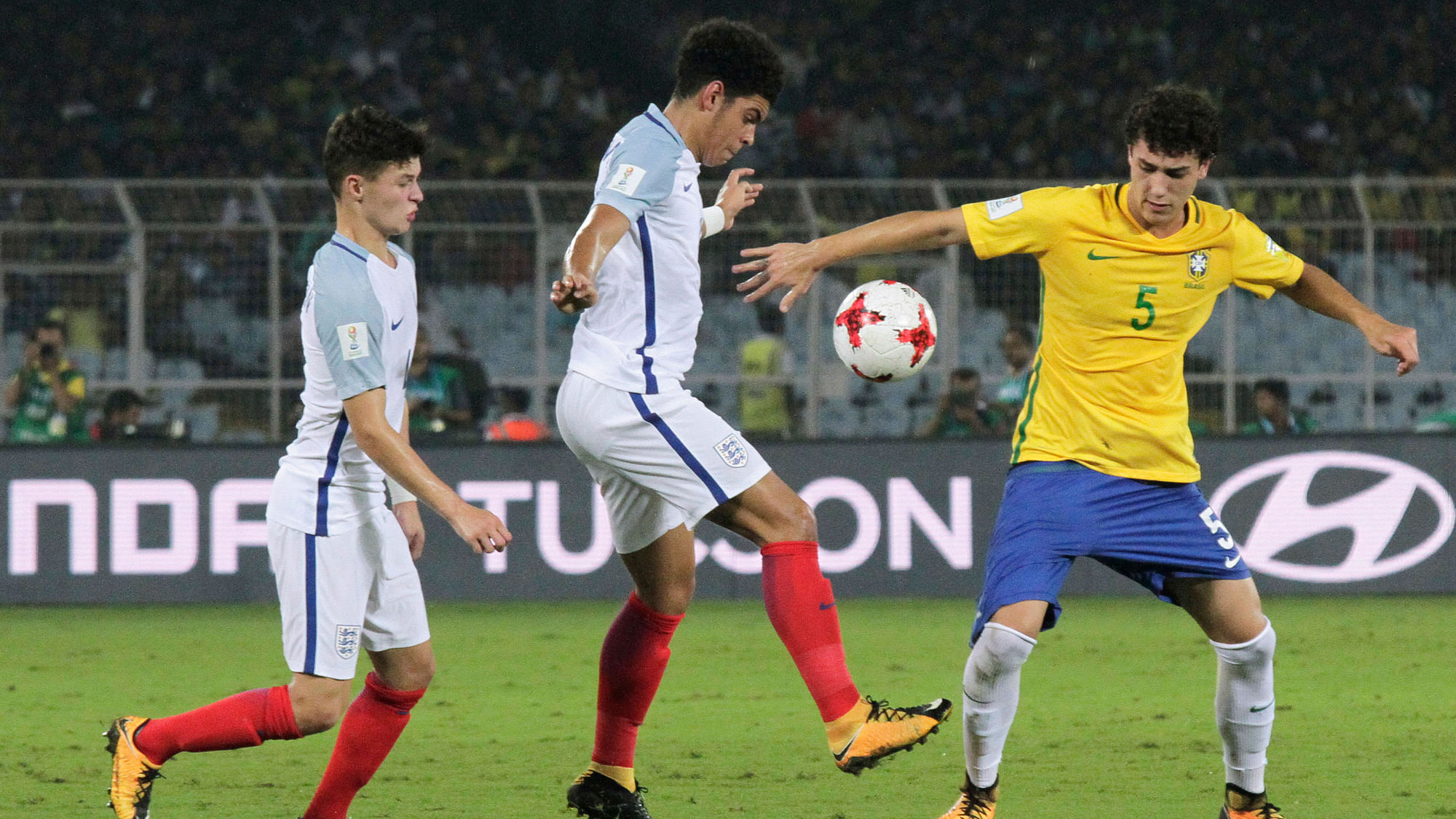 Brazil’s Victor Bobsin duels for the ball against England’s Morgan Gibbs.