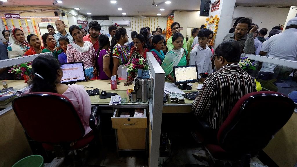 People stand in a queue to deposit Rs 500 and Rs 1,000 banknotes inside a bank in Kanpur on 10 November  2016. 