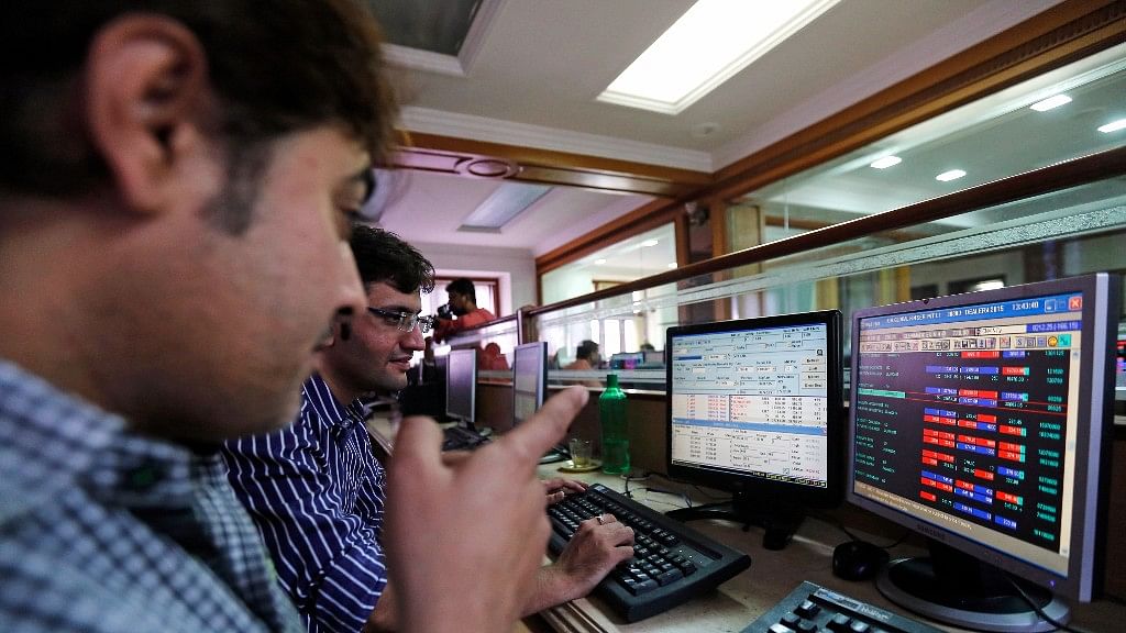 Brokers trade at their computer terminals at a stock brokerage firm in Mumbai.