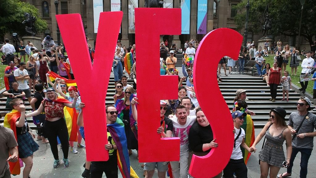 People celebrate after the announcement of the same-sex marriage postal survey result in front of the State Library of Victoria in Melbourne, Australia, on 15 November 2017.
