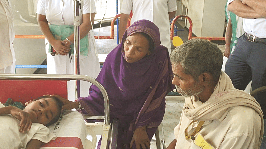 Ravita’s parents sit by her bedside at Gokuldas Tejpal Hospital.