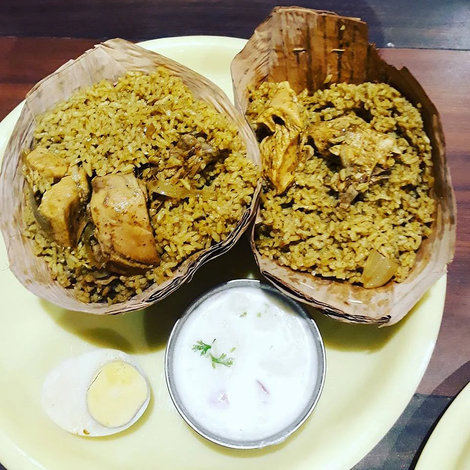 Donne Biryani served in cups made of palm leaves.