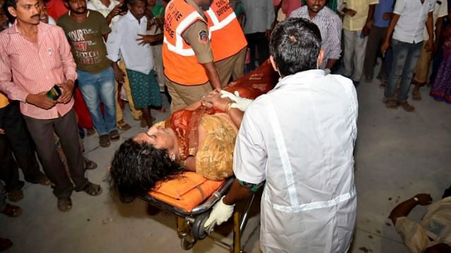 An injured woman being taken to hospital after the overloaded boat carrying 38 people capsized in the Krishna river near Vijayawada.