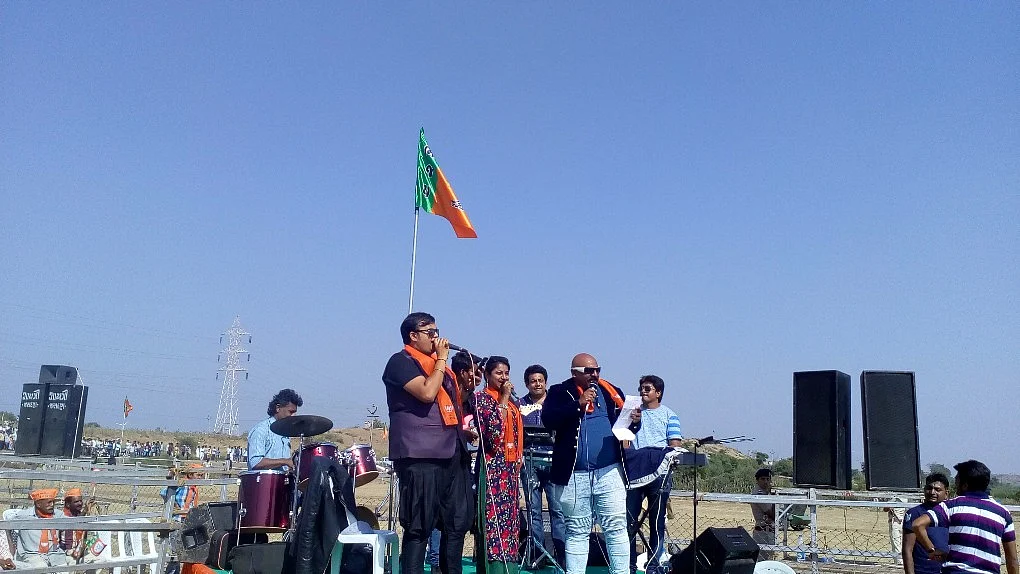 Popular Gujarati Singer Arvind Vegada performs for the crowd before Modi’s rally starts in Jasdan, on Monday.