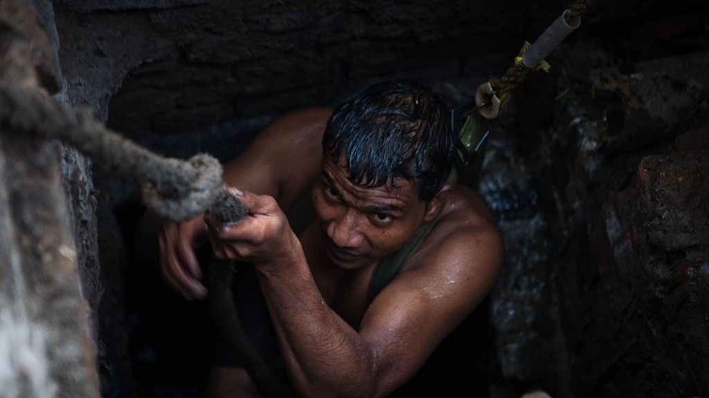 Kuldeep climbs out of the sewer in Sector 10, Ghaziabad.&nbsp;