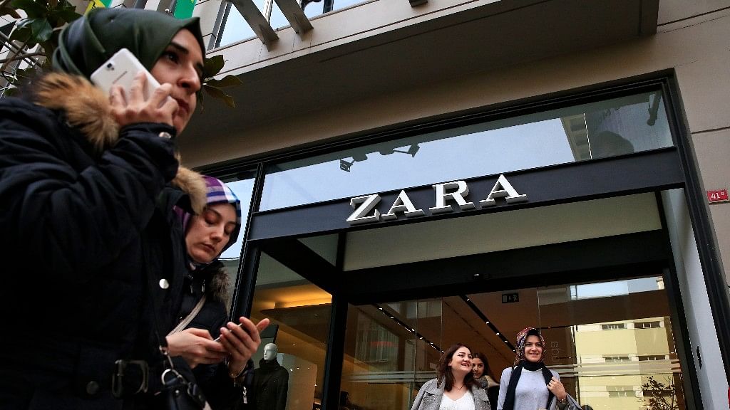 People exit and walk past a fashion retailer Zara branch in an Istanbul upscale neighbourhood.