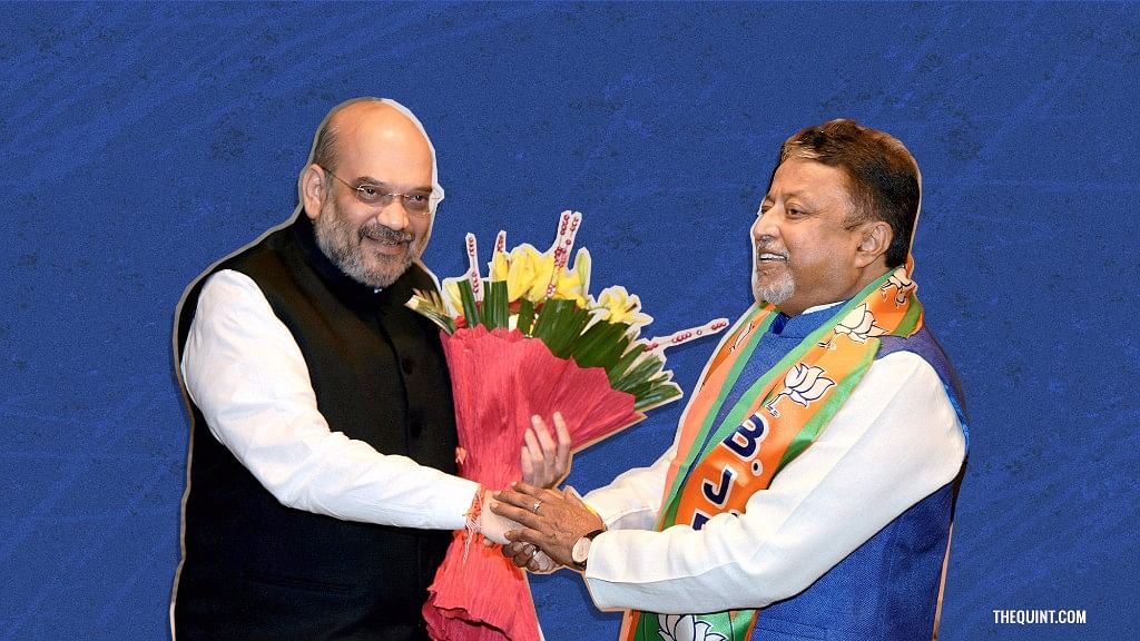 BJP president Amit Shah welcomes former railways minister Mukul Roy into the party.