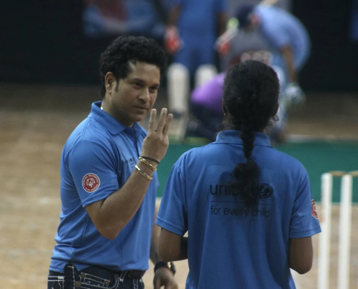 Cricket legend Sachin Tendulkar plays cricket with children during an exhibition match organised by the UNICEF in New Delhi, on 19 November 2017.