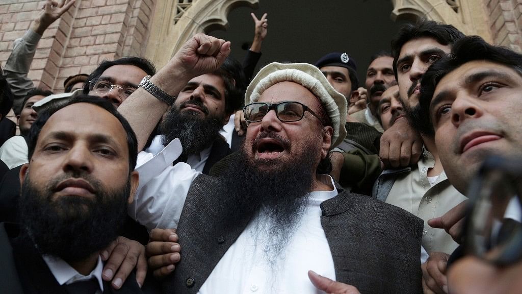 Hafiz Saeed, head of the Pakistani religious party, Jamaat-ud-Dawa, gestures outside a court in Lahore.