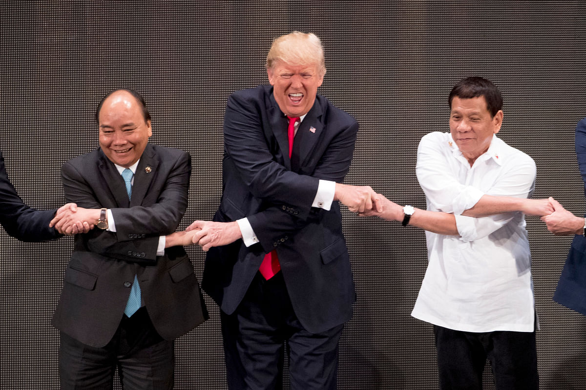 The announcer’s instructions about the “ASEAN-way handshake” appeared for a moment to baffle Trump.